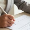 cropped-anonymous-business-woman-checking-agreement-before-signing